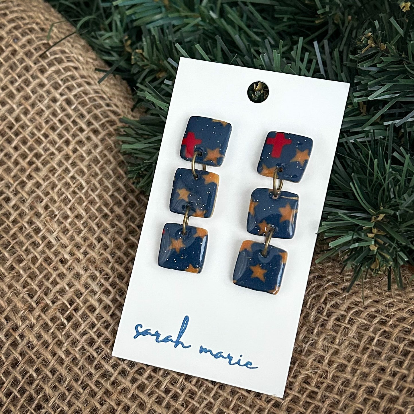 three squares dangle - navy blue earrings with gold stars and red cross