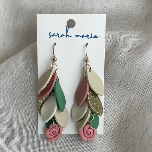 Pink, green and ivory earrings on a 'Sarah Marie' branded card against a textured fabric background