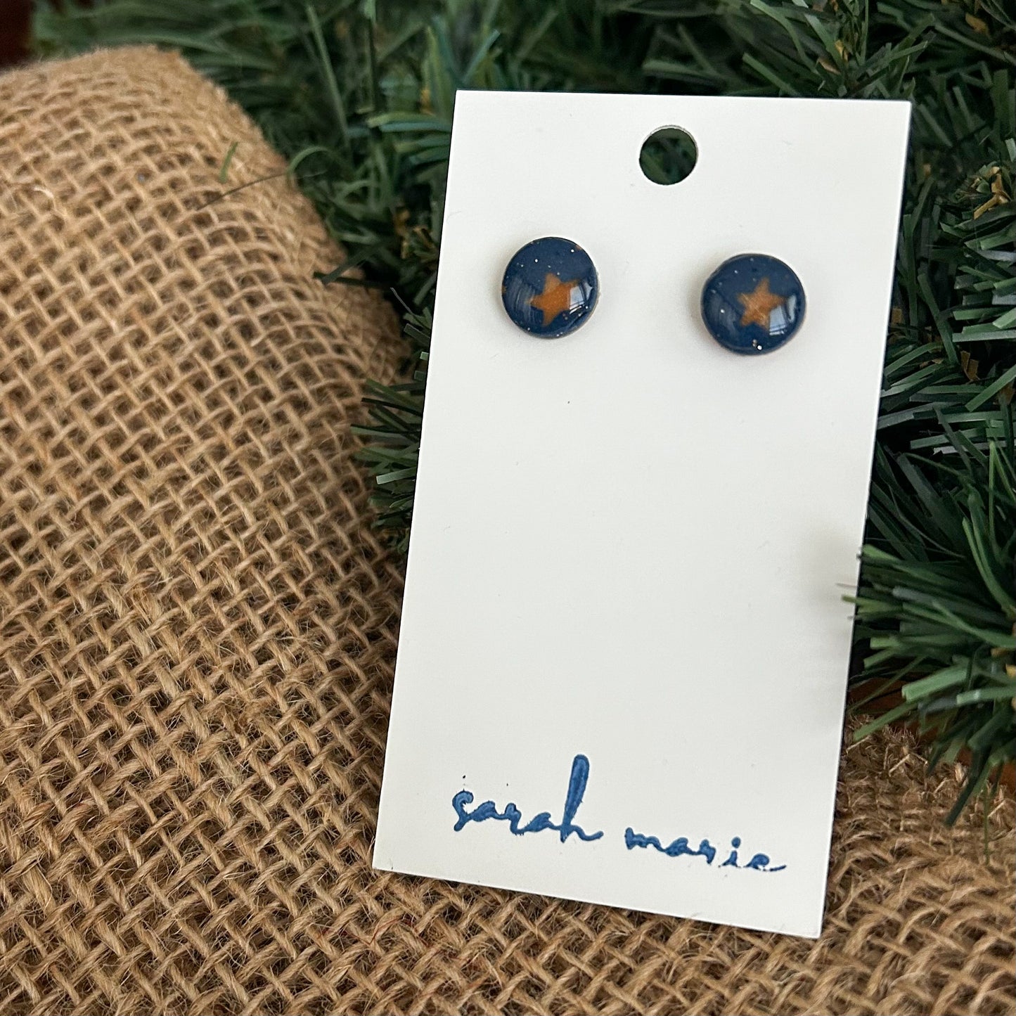 circle shaped navy blue stud earrings with gold stars